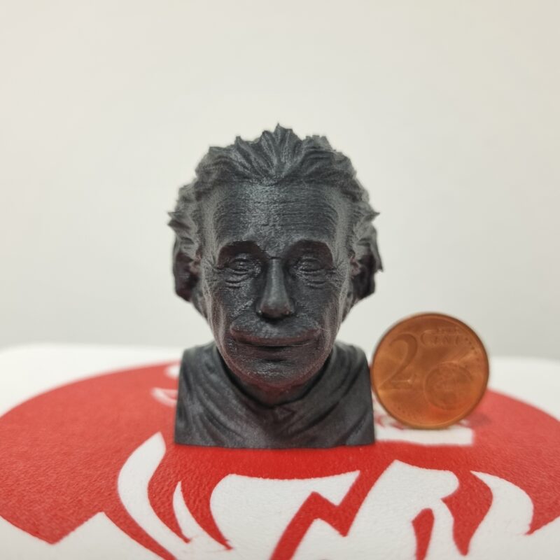 Minature Einstein Bust next to a Cent coin